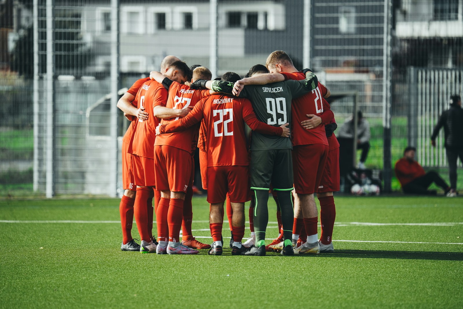 Soccer team gathering in a huddle before play
